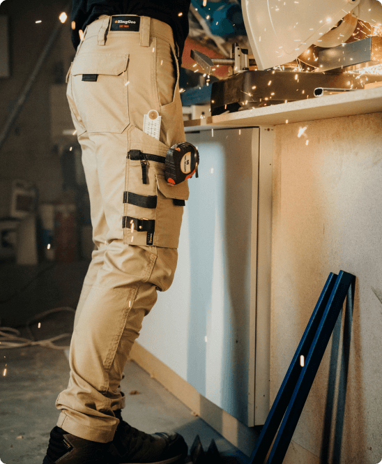 Man wearing Traditional Workwear in work shop using grinder - Stitched-Up Workwear - Embroidery Mackay